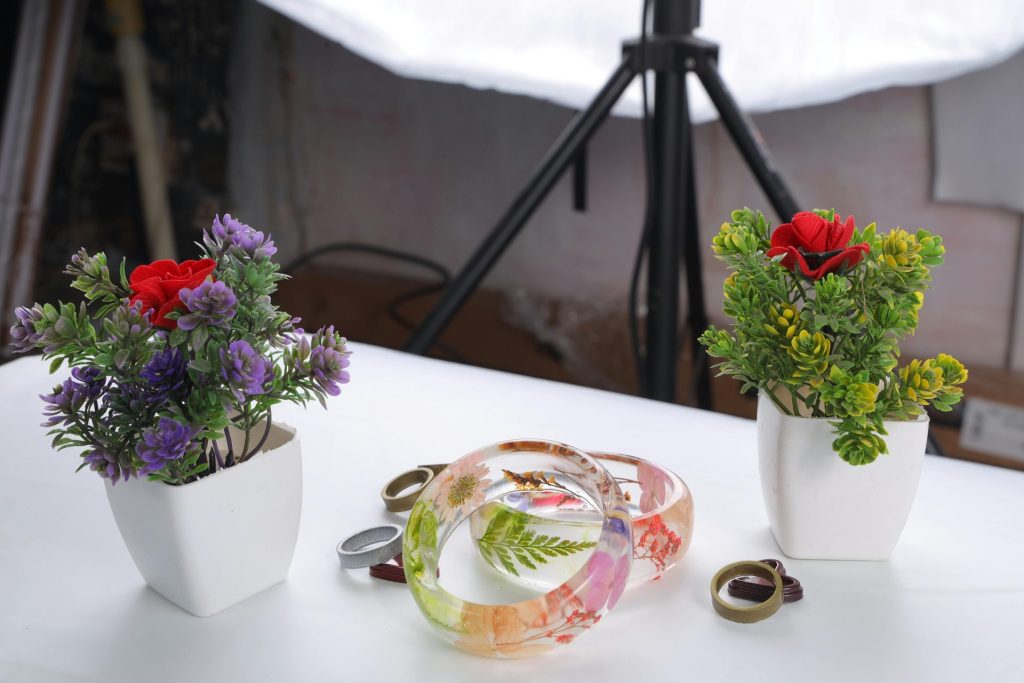 Elegant resin bracelets showcased elegantly with potted flowers, perfect for a stylish jewelry collection.